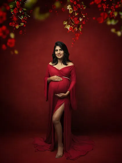 A full-length shot showing the beautiful slit in the red gown, adding a modern touch to a classic portrait.