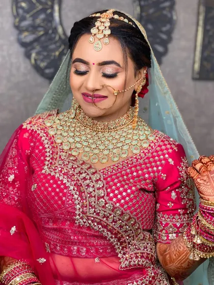 A close-up of the same bride, with her eyes closed to showcase the beautiful glittery eye makeup.
