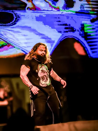 A candid moment on stage, capturing the focus and intensity of our frontman between songs.