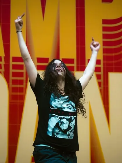 Pure joy and release on the dance floor. A student lets loose during a high-energy session at Camp Big Dance, feeling the music and the moment.
