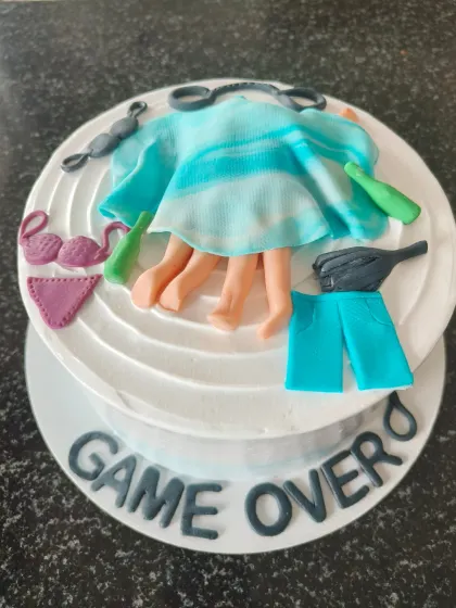 A hilarious "Game Over" themed bachelorette cake with fondant details for a fun party.