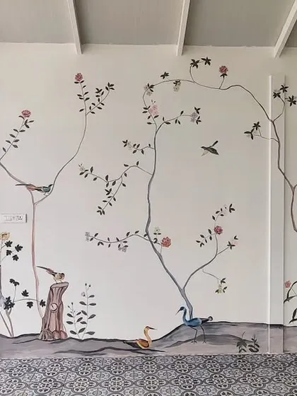 The full expanse of the main wall of the French mural, showcasing the balanced composition of trees, birds, and flowers.