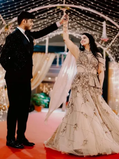 A classic dance pose in a tunnel of twinkling fairy lights. The bride's flowing gown and the romantic lighting create a timeless and dreamy portrait, perfect for any engagement album.