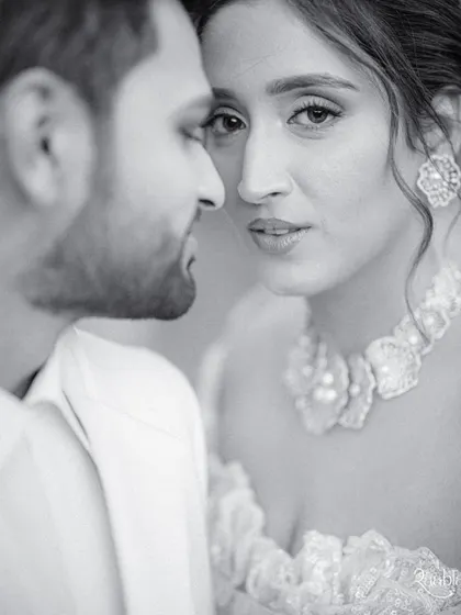 An intense and intimate black and white close-up, capturing a powerful, unspoken connection between the couple.