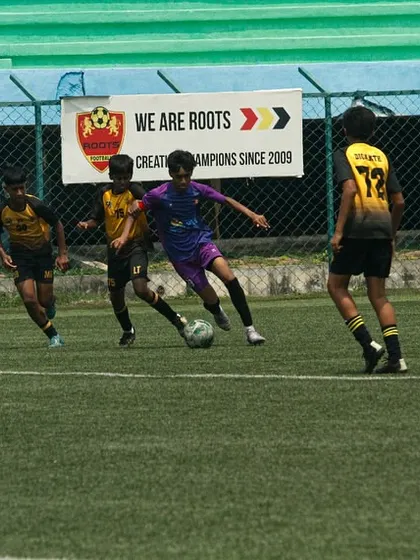 Weaving through the opposition. A Playsmart player showcases their dribbling skills under pressure during the U-15 YPL finals.