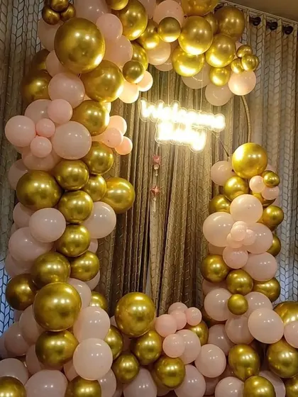 A lush pink and gold balloon arch, perfect for an elegant birthday or anniversary.