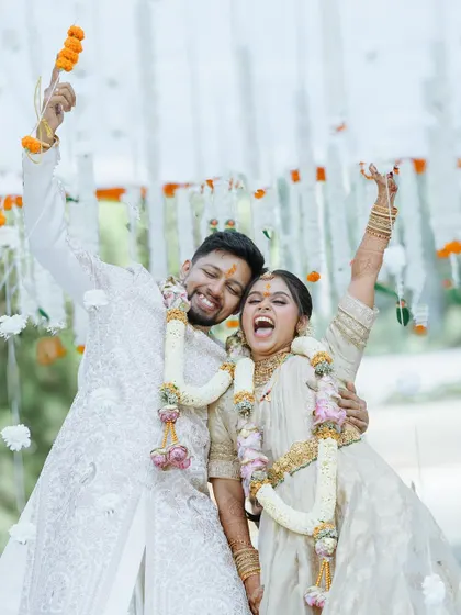 Pure exhilaration! This shot of the couple celebrating after their ceremony captures the peak of their happiness and excitement for the future.