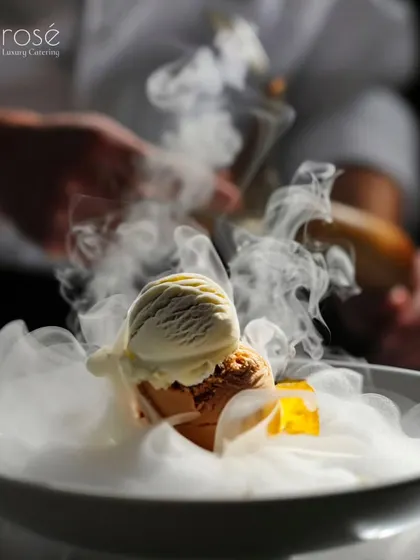 We love to add a touch of culinary theatre to our dessert offerings. This dish, featuring scoops of gourmet ice cream enveloped in a dramatic cloud of smoke, provides a memorable and photo-worthy conclusion to your event.