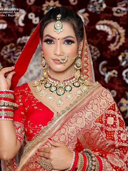 A beautiful portrait of a bride in a red saree, with her hair styled in a classic updo adorned with traditional jewelry.