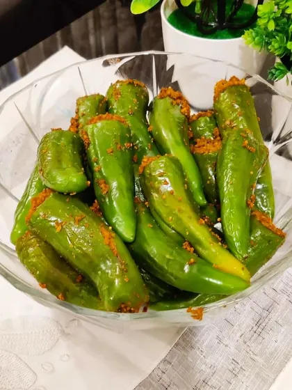 A bowl of our stuffed green chilli pickle, ready to be served. It's a perfect side for any meal.