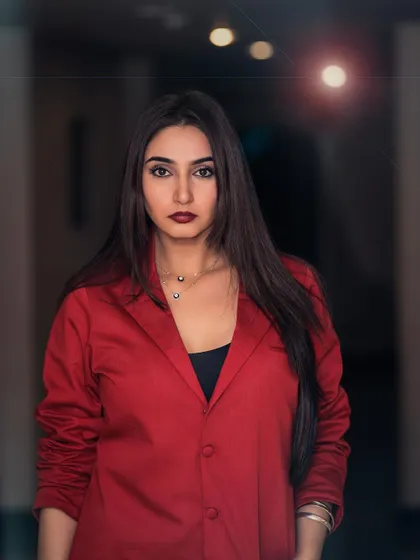 A powerful portrait of Ragini Dwivedi for her brand ambassadorship announcement. The red blazer and direct gaze convey confidence and professionalism, perfect for corporate and commercial campaigns.