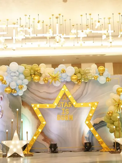 Welcoming a new life is a celestial event. For this 'A Star Is Born' naming ceremony, I designed a dreamy stage with a glowing star, soft clouds, and a marble-effect backdrop to celebrate the family's newest little star.