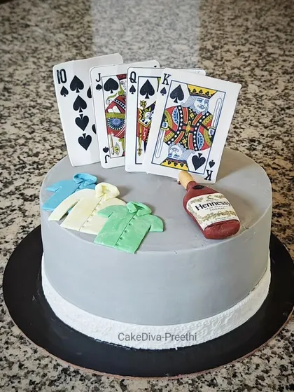 If you love poker, this cake is for you. This design features an almost-royal flush with edible playing cards, a miniature Hennessy bottle, and tiny fondant shirts.