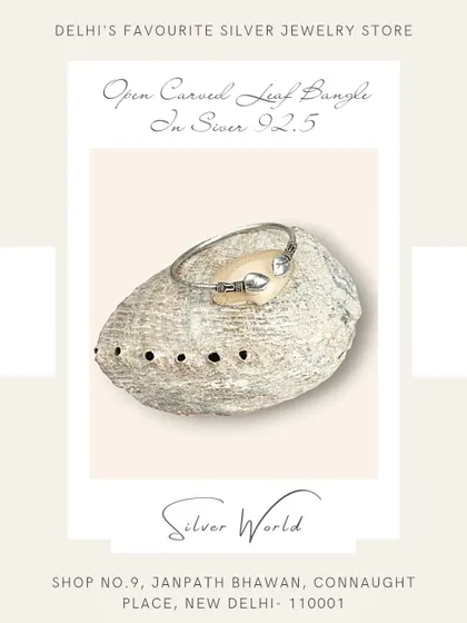 An open carved leaf bangle in pure 92.5 silver. This free-size design is delicate and inspired by nature.
