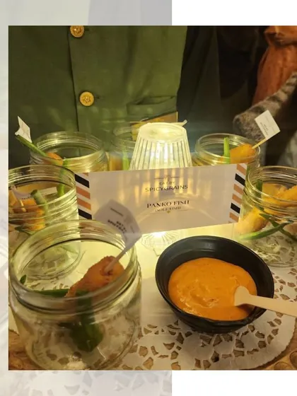 Panko Fish served in individual jars with a creamy dipping sauce, a stylish and convenient appetizer.