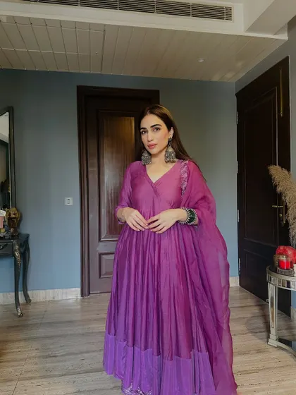 A full-length standing shot of the purple anarkali. The outfit is both regal and comfortable.