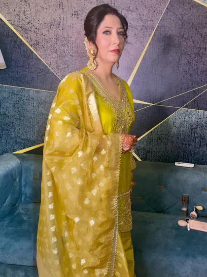 A poised and elegant guest, ready for the wedding festivities. The makeup is classic and radiant.