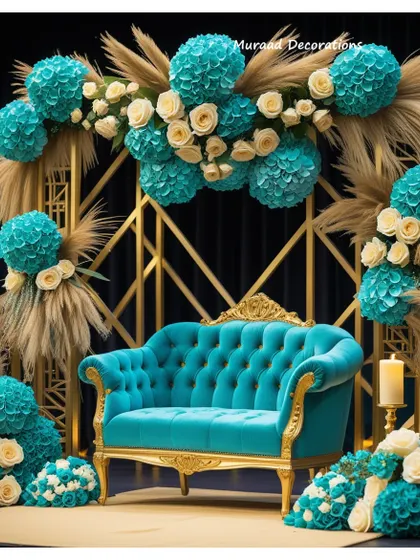 This wedding stage combines modern geometry with soft, natural elements. I used a gold-toned geometric frame as the backdrop, adorned with turquoise and cream floral arrangements and dried pampas grass for a unique, contemporary look. The tufted turquoise sofa completes this stylish setup.