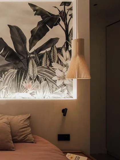 The classic Secto Design pendant used as a bedside light. Its warm, downward-focused light is perfect for reading, and its sculptural form adds a touch of design sophistication.