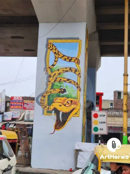 A thrilling 3D snake mural on a pillar, designed to look like it's bursting out of a frame. This kind of unexpected public art makes a daily commute more exciting.
