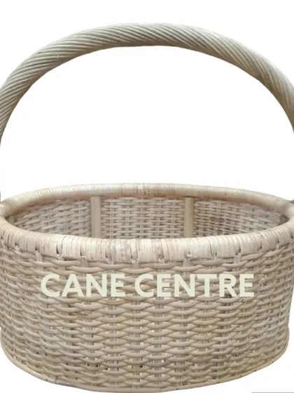 A classic, all-purpose round basket made from natural, light-colored cane. Its simple, tight weave and strong handle make it a durable choice for carrying items or for home display.