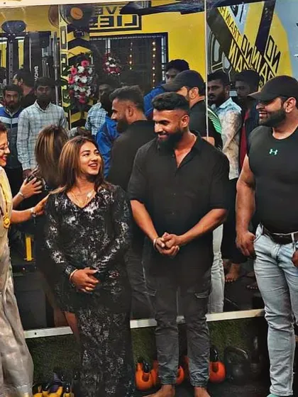 Sharing a laugh with fellow guests at a gym anniversary. These events are a great way to connect with the fitness family.