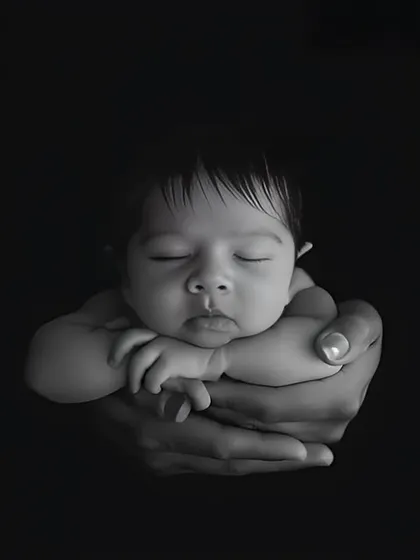 I believe every photograph should tell a story. This classic black and white portrait, with a newborn held safely in their parent's hands, is one of my all-time favorites because it captures the pure love and connection of those first few days.