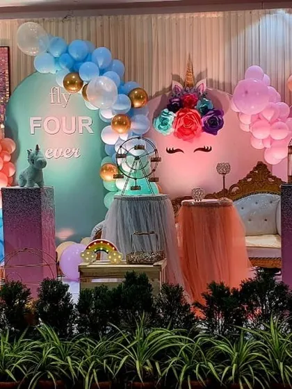 This magical unicorn and rainbow theme uses a soft pastel color palette, a sequin panel, and multiple themed backdrops for a whimsical feel.