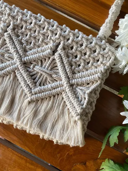 We love the details in this close-up of our macrame cross-body bag. Every knot is tied by hand to create this beautiful, durable pattern.