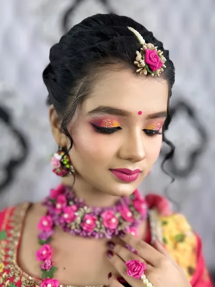 A close-up of the eye makeup for the Haldi look demonstration, featuring a pop of yellow and pink glitter.