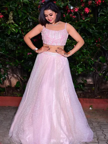 Another full-length pose, highlighting the sparkle and texture of the lehenga skirt.