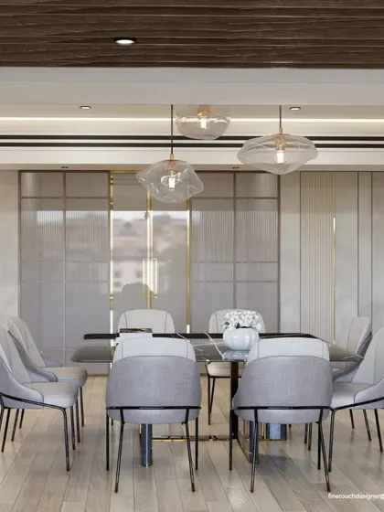 This view highlights the fluted glass and gold-trimmed partitions behind the dining set. These elements add a layer of texture and privacy while contributing to the room's overall elegant and high-end feel.