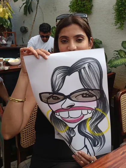 She's hiding half her face, but her caricature shows her full, smiling personality.