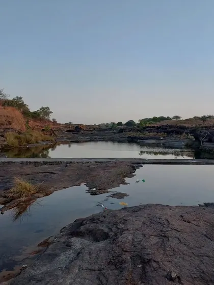 A quiet, rocky stream at dusk. These are the places we seek out for quiet reflection. The stillness of the water and the vastness of the landscape help to quiet the mind.