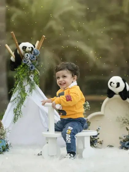 A magical moment from an outdoor-themed toddler session. The twinkling lights and playful setup create a whimsical and enchanting portrait.