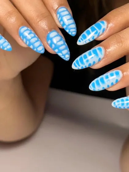 The full set of these eye-catching blue patterned nails. This is a great example of how to create a full set of statement art that is cohesive and beautiful.
