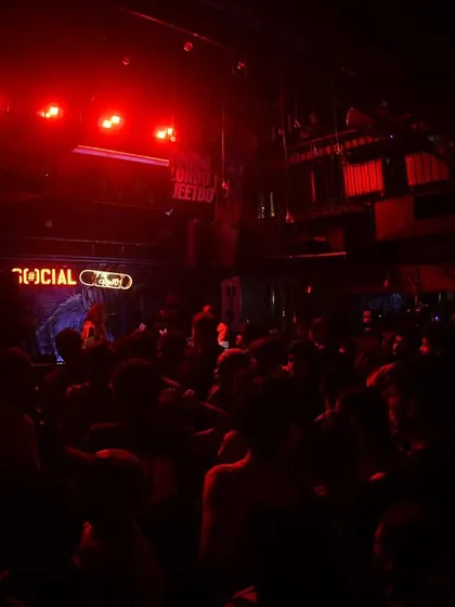 The club plunged in red light, with the crowd ready for the beat to drop. The anticipation is real.