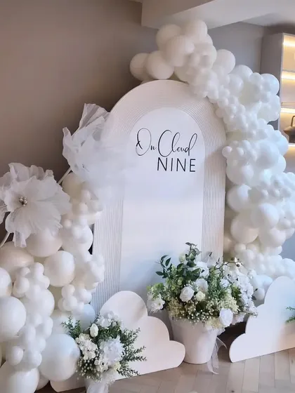 The "On Cloud Nine" theme is a dreamy and elegant choice for a baby shower. I use all-white balloon clouds, a custom arched backdrop, and delicate floral arrangements to create a heavenly atmosphere.