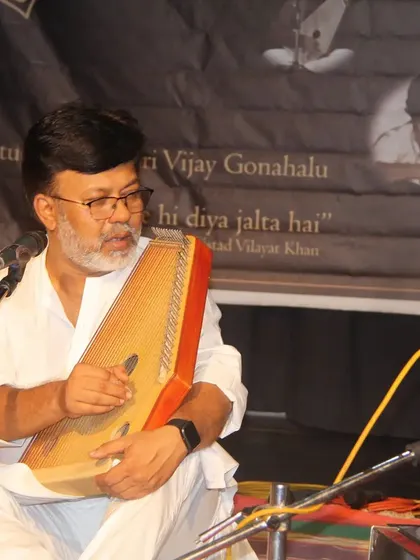 A guest artist performing on the swarmandal during our Gurupoornima celebration. We invite many respected musicians to share their art on this auspicious day.