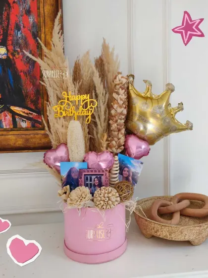A beautiful birthday bouquet box with dried pampas grass, foil heart balloons, and personalized photos. This is a perfect gift for someone who loves a rustic, boho aesthetic.