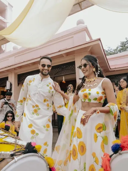 A Haldi ceremony that was pure sunshine and smiles. The couple, dressed in coordinated sunflower-print outfits, made their entrance with dhol players, setting a fun and festive tone for the day.