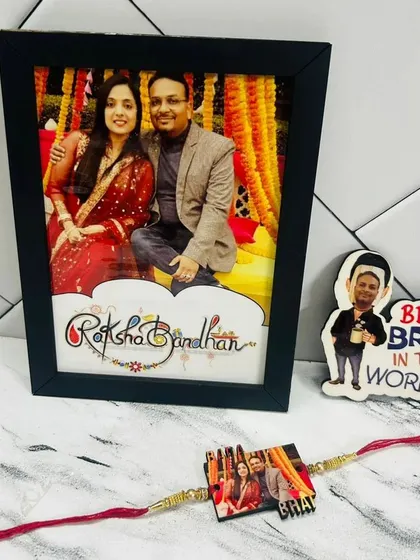 A lovely Rakhi gift set featuring a framed photo, a custom rakhi with a picture, and a "Best Bro in the World" caricature magnet.