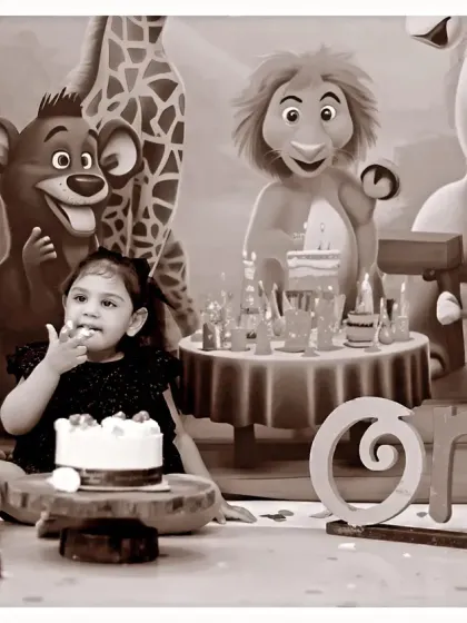 A sepia-toned version of our jungle-themed cake smash, adding a timeless and artistic feel to the birthday celebration photos.