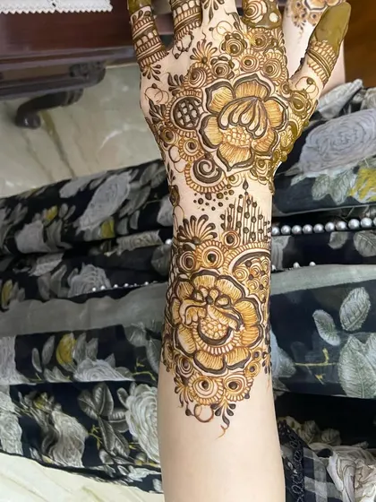 The back of the hand for the same design, showing a floral pattern extending up the arm.