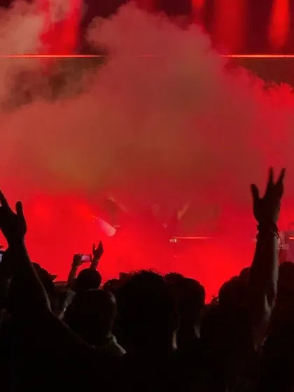 The party goes on, rain or shine. The red smoke and lights created an intense atmosphere at the Sao Joao festival.