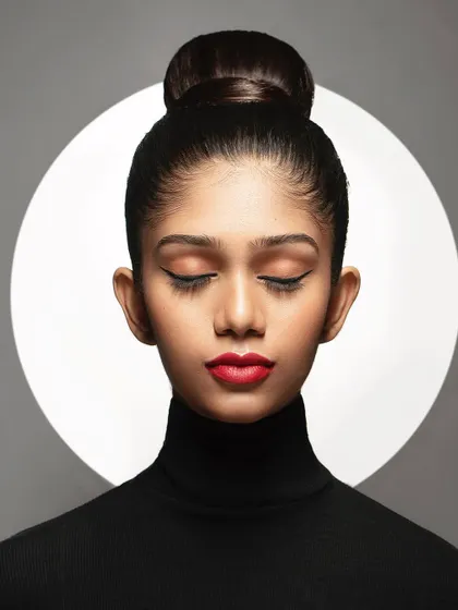 Here, I experimented with a background light to create a halo effect. This adds a graphic, almost spiritual element to the portrait, turning a simple headshot into a more artistic and conceptual piece.