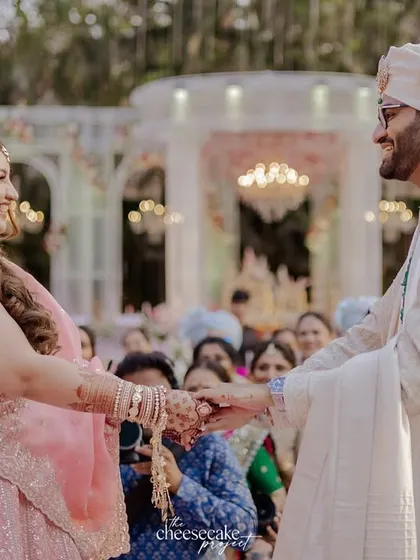 The couple holding hands for the first time on their wedding day.