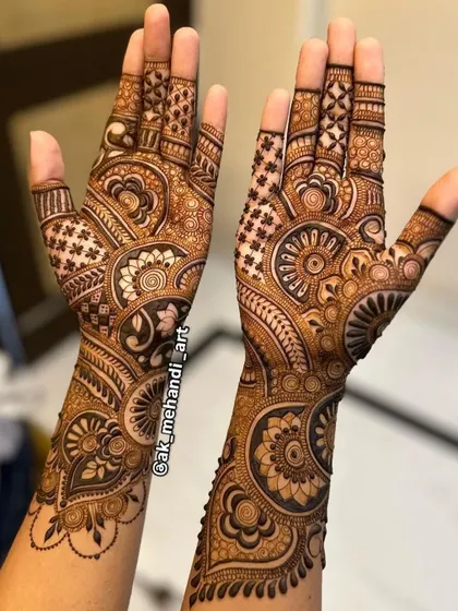 A matching pair of engagement mehndi designs. The patterns are intricate but leave some skin showing, creating a beautiful contrast that highlights the artwork.