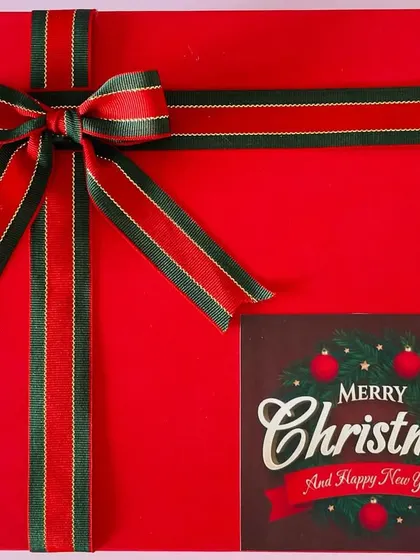 Getting into the holiday spirit with our Christmas hamper, wrapped in a festive red box with a classic red and green ribbon.
