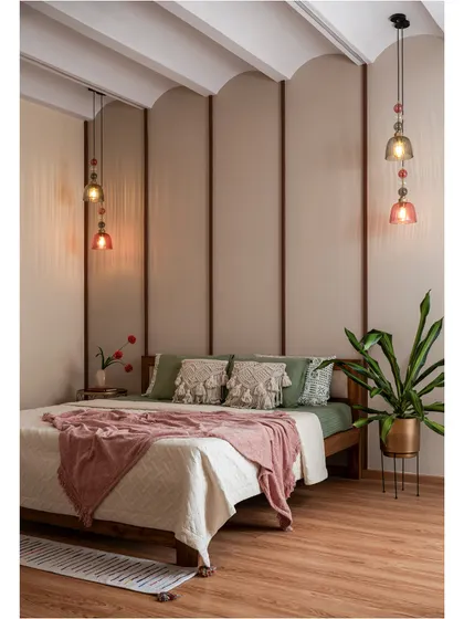Soft, serene, and effortlessly inviting. This bedroom uses warm wood tones, a gracefully arched fabric-paneled wall, and earthy green and pink hues to create a cozy retreat designed to soothe the senses.